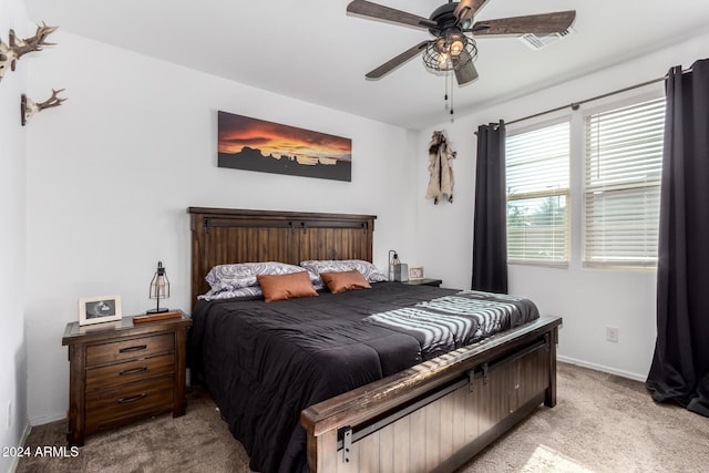 bedroom featuring light colored carpet and ceiling fan