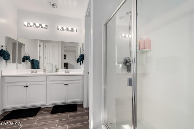 bathroom featuring vanity and an enclosed shower