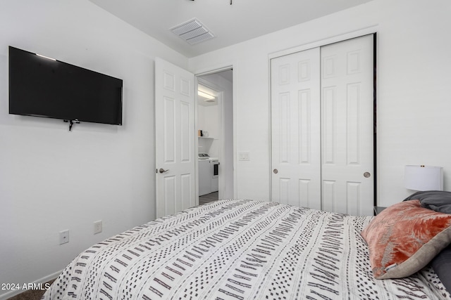 bedroom with washer / clothes dryer and a closet