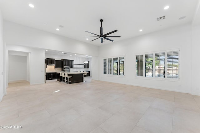 4547 S Banning Dr, Gilbert, AZ 85297 - living area with visible vents, baseboards, a high ceiling, ceiling fan, and recessed lighting