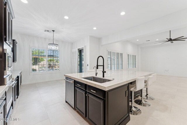 4547 S Banning Dr, Gilbert, AZ 85297 - kitchen with visible vents, a sink, a kitchen bar, recessed lighting, and a center island with sink