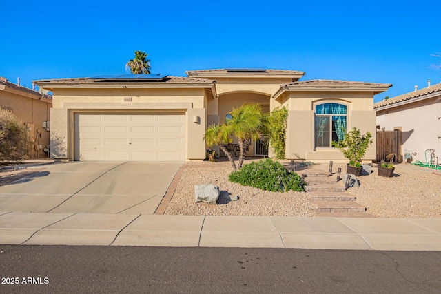 view of front of home with a garage and solar panels