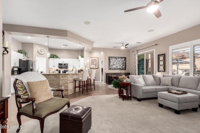 tiled living room featuring ceiling fan