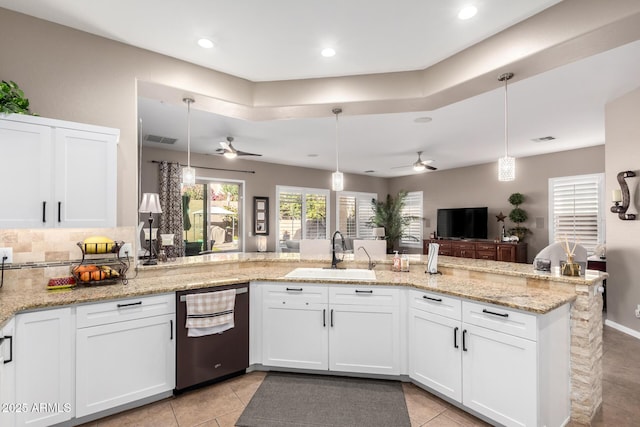 kitchen with sink, decorative light fixtures, dishwasher, and white cabinets