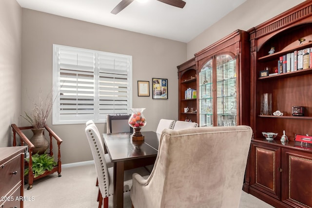 carpeted dining space featuring ceiling fan