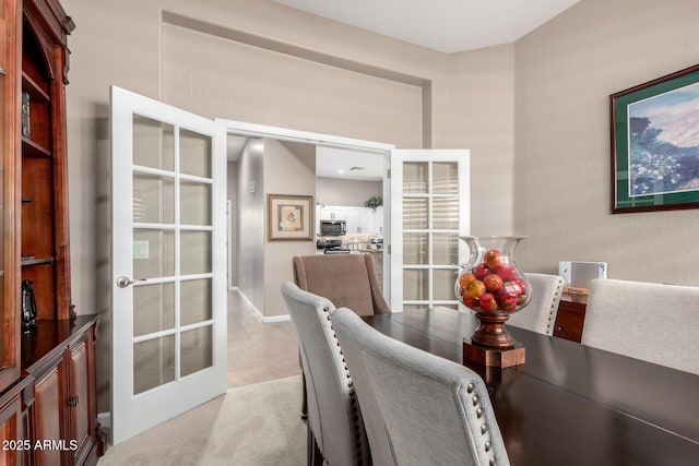 dining space with light tile patterned floors and french doors