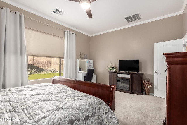 bedroom with ornamental molding, light colored carpet, and ceiling fan