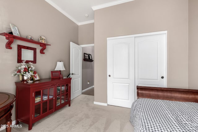 carpeted bedroom featuring crown molding and a closet