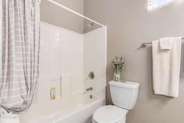 bathroom with toilet and shower / bath combo with shower curtain