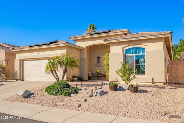 view of front of house featuring a garage and solar panels