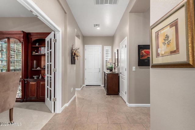 hallway featuring light tile patterned flooring