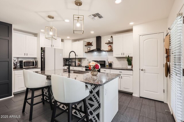 128 E Bluejay Dr, Chandler, AZ 85286 - kitchen featuring range, a sink, wall chimney range hood, freestanding refrigerator, and stainless steel microwave
