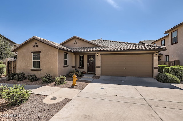 128 E Bluejay Dr, Chandler, AZ 85286 - view of front of home with a garage, concrete driveway, a tile roof, and stucco siding