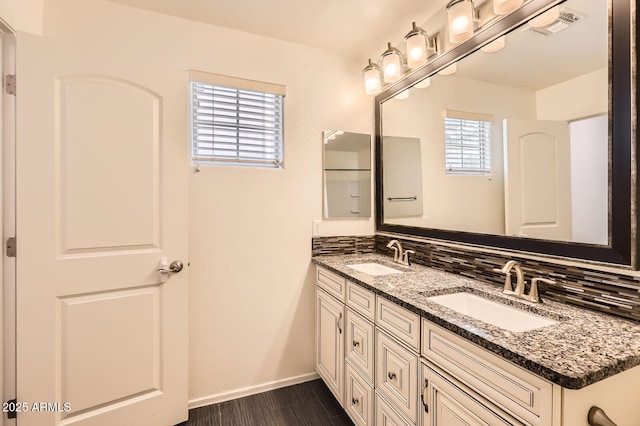 128 E Bluejay Dr, Chandler, AZ 85286 - full bathroom featuring double vanity, baseboards, backsplash, and wood finished floors