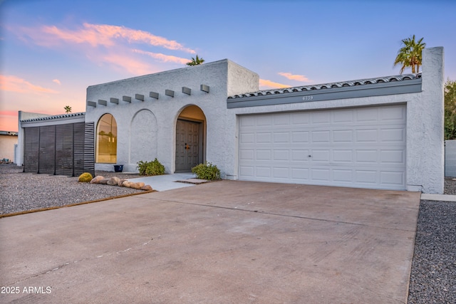 6739 E Thunderbird Rd, Scottsdale, AZ 85254 - mediterranean / spanish house with driveway, a garage, and stucco siding