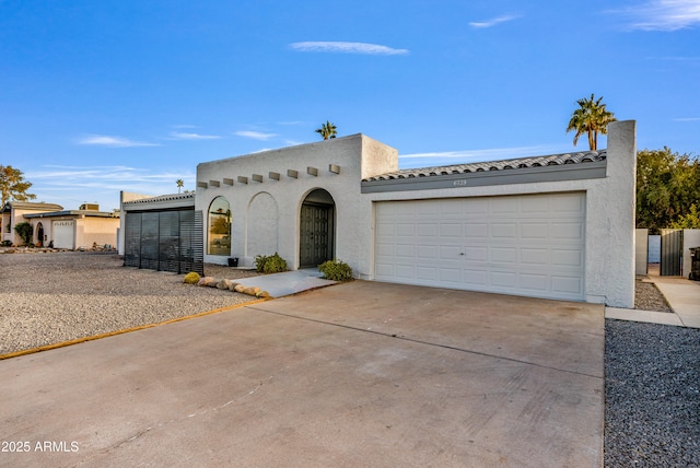 6739 E Thunderbird Rd, Scottsdale, AZ 85254 - mediterranean / spanish-style home featuring stucco siding, concrete driveway, an attached garage, and a tile roof