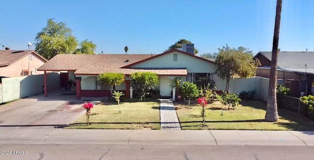 single story home with a front yard and a carport