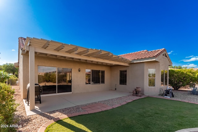 back of property featuring a pergola, a patio, and a lawn