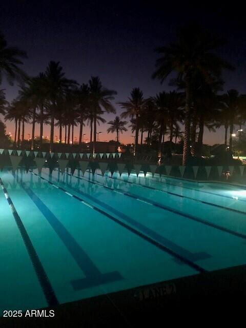 view of pool at dusk