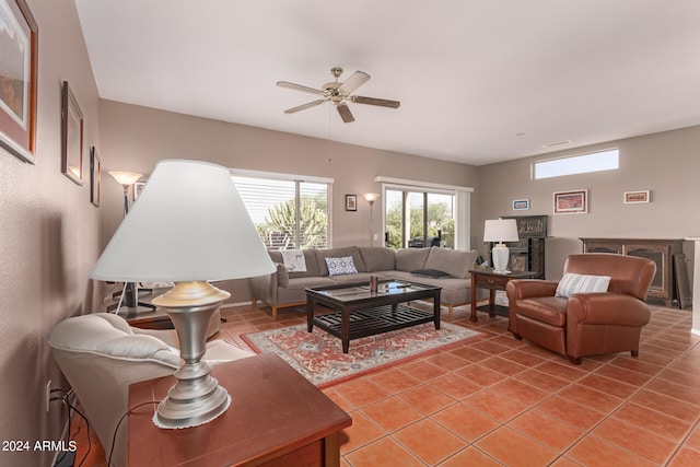 tiled living room with ceiling fan