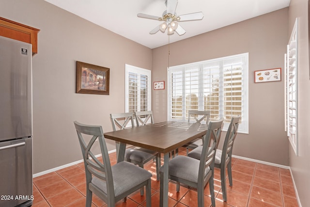 dining space with ceiling fan and light tile patterned flooring