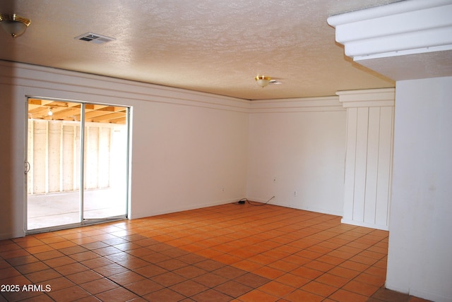 spare room with visible vents and a textured ceiling