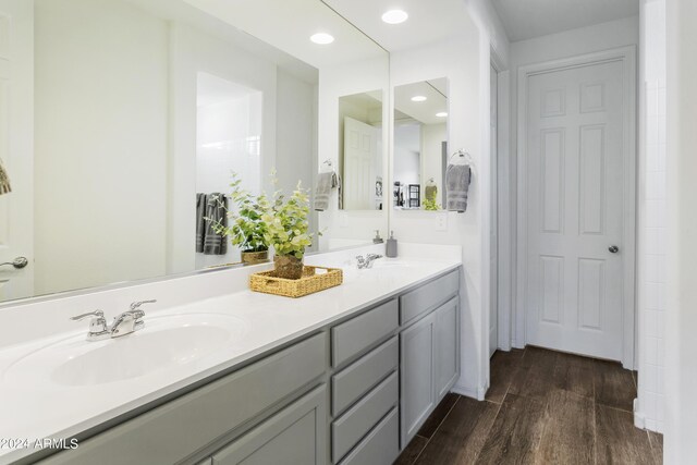 7180 W Tombstone Trl, Peoria, AZ 85383 - bathroom with wood finished floors, double vanity, and recessed lighting