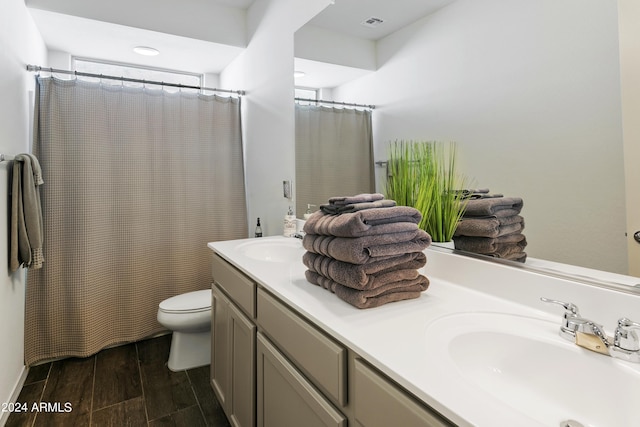 7180 W Tombstone Trl, Peoria, AZ 85383 - bathroom with toilet, double vanity, wood finished floors, and a shower with curtain