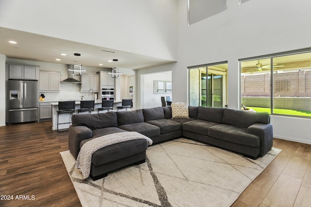 7180 W Tombstone Trl, Peoria, AZ 85383 - living area with dark wood finished floors, recessed lighting, a towering ceiling, and baseboards