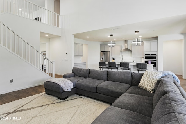 7180 W Tombstone Trl, Peoria, AZ 85383 - living room with wood finished floors, stairs, baseboards, recessed lighting, and a high ceiling