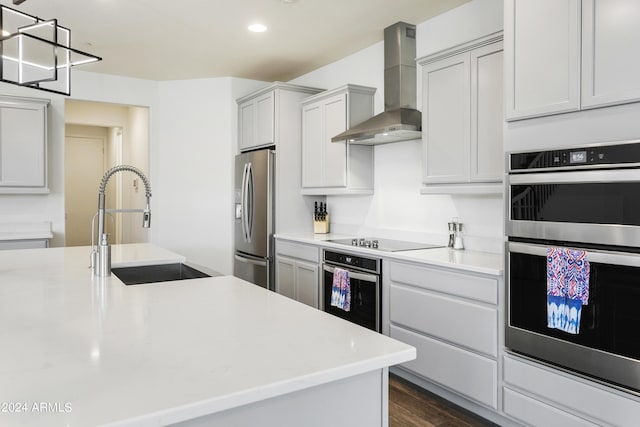 7180 W Tombstone Trl, Peoria, AZ 85383 - kitchen with wall chimney exhaust hood, stainless steel appliances, a sink, light countertops, and dark wood-style flooring