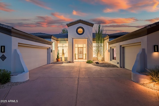 7775 E Fledgling Dr, Scottsdale, AZ 85255 - view of front of house with driveway, a garage, and stucco siding