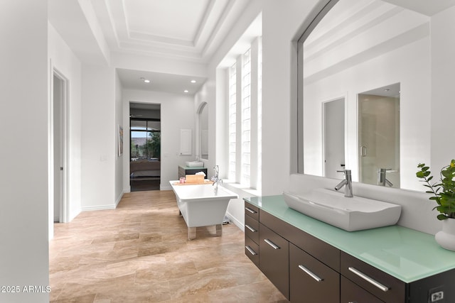 7775 E Fledgling Dr, Scottsdale, AZ 85255 - ensuite bathroom with a freestanding tub, vanity, a raised ceiling, and recessed lighting