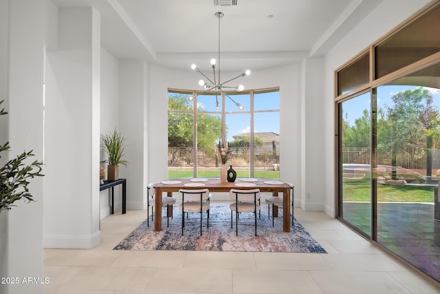 7775 E Fledgling Dr, Scottsdale, AZ 85255 - dining space featuring a tray ceiling, a chandelier, and light tile patterned floors