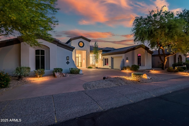 7775 E Fledgling Dr, Scottsdale, AZ 85255 - mediterranean / spanish home featuring stucco siding, an attached garage, and concrete driveway