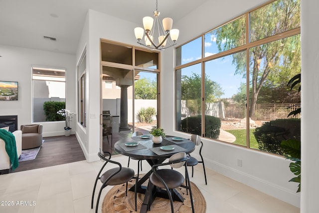 7775 E Fledgling Dr, Scottsdale, AZ 85255 - dining space with a chandelier, tile patterned floors, and decorative columns
