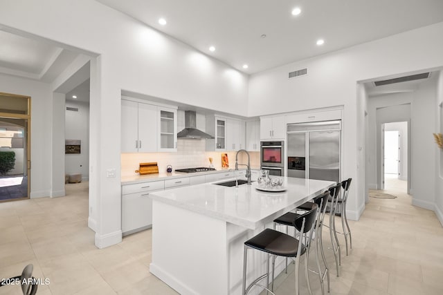 7775 E Fledgling Dr, Scottsdale, AZ 85255 - kitchen with wall chimney range hood, stainless steel appliances, light countertops, backsplash, and recessed lighting