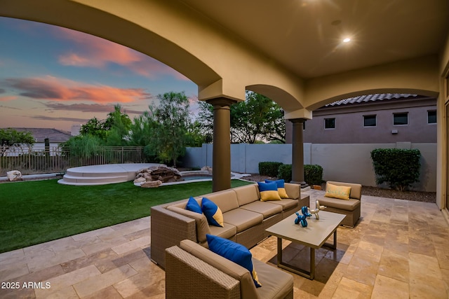 7775 E Fledgling Dr, Scottsdale, AZ 85255 - patio terrace at dusk featuring outdoor lounge area, a patio area, and a fenced backyard
