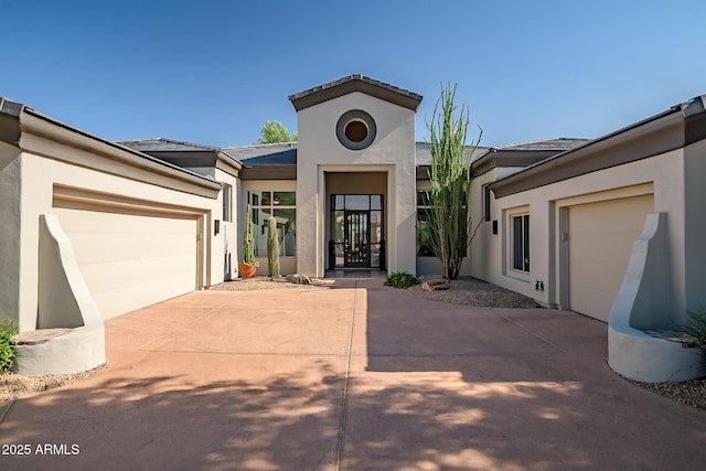 7775 E Fledgling Dr, Scottsdale, AZ 85255 - view of front facade with concrete driveway, a garage, and stucco siding