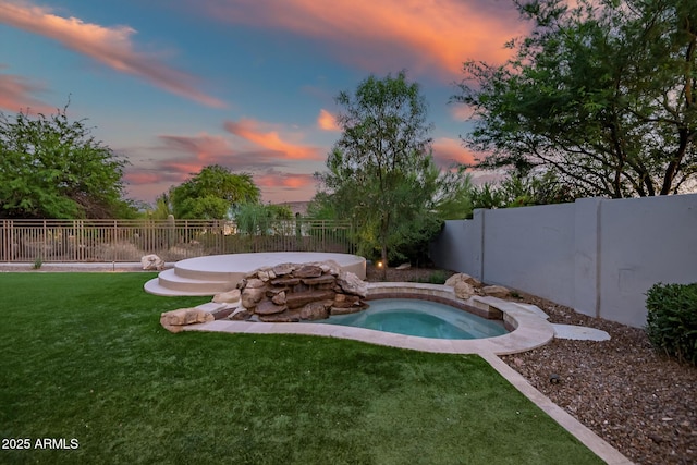 7775 E Fledgling Dr, Scottsdale, AZ 85255 - pool at dusk featuring an in-ground hot tub and a fenced backyard
