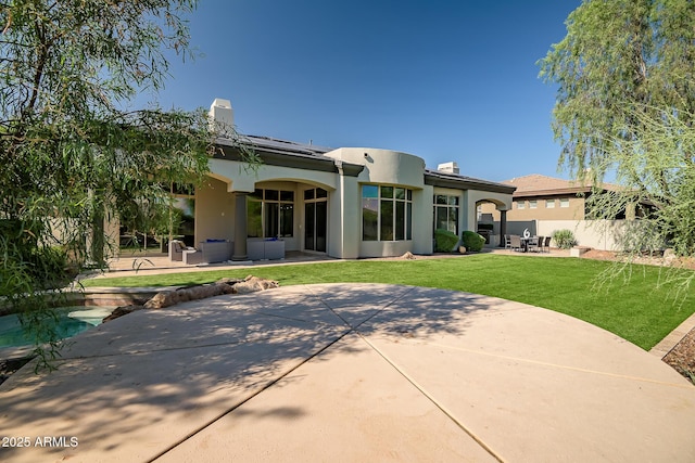7775 E Fledgling Dr, Scottsdale, AZ 85255 - rear view of property with a patio area, stucco siding, an outdoor living space, and a chimney