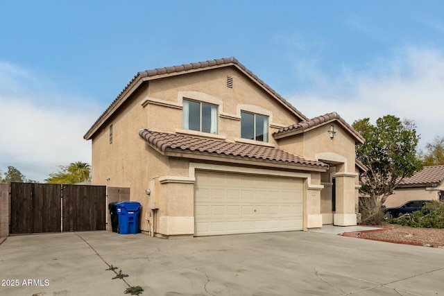 mediterranean / spanish-style home with driveway, an attached garage, a tile roof, and stucco siding