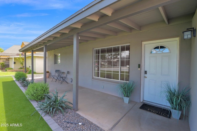 4137 E Sells Dr, Phoenix, AZ 85018 - doorway to property with stucco siding, a patio, and a yard