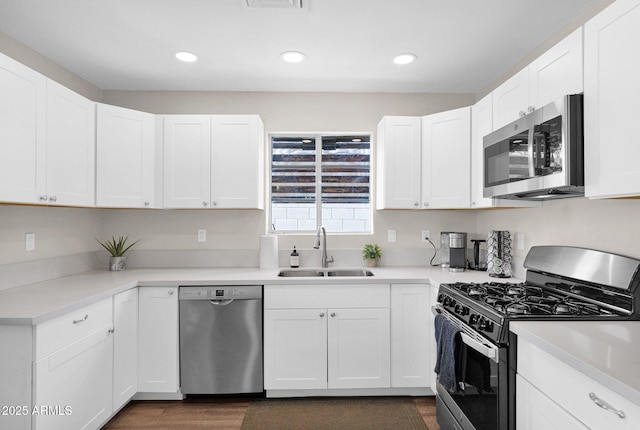 4137 E Sells Dr, Phoenix, AZ 85018 - kitchen featuring stainless steel appliances, a sink, white cabinets, recessed lighting, and light countertops