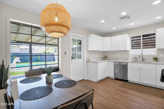4137 E Sells Dr, Phoenix, AZ 85018 - kitchen with dishwasher, a sink, wood finished floors, plenty of natural light, and recessed lighting
