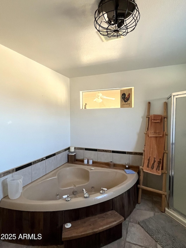 bathroom with a bathing tub and tile patterned flooring