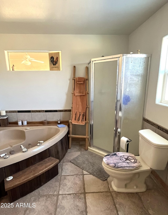 bathroom featuring shower with separate bathtub, tile walls, and toilet