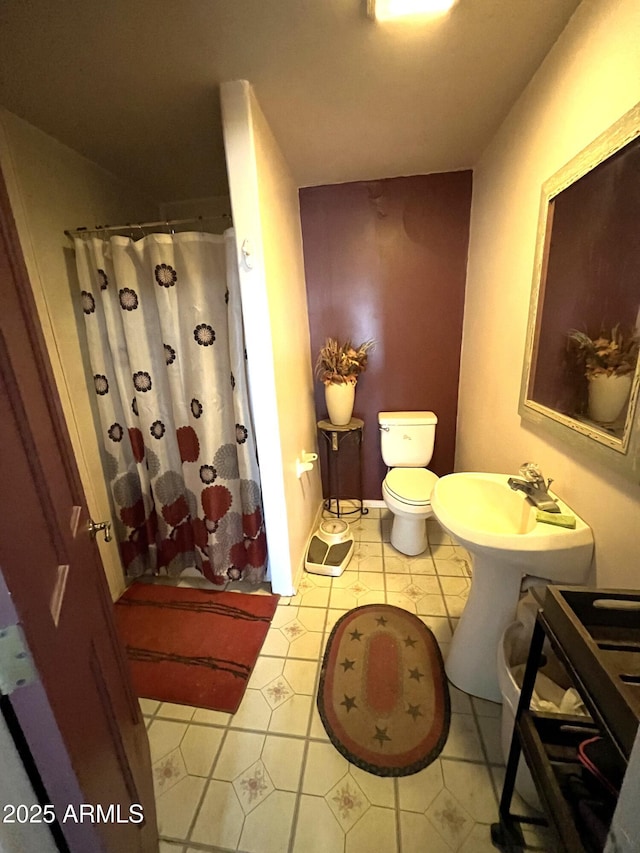 bathroom with toilet, tile patterned floors, and a shower with shower curtain