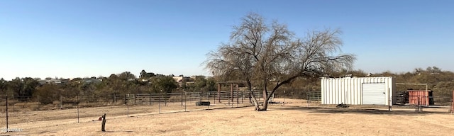 view of yard featuring an outbuilding and a rural view