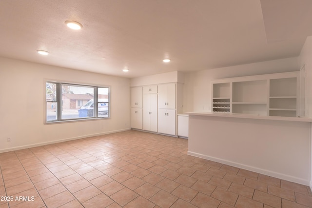 spare room featuring light tile patterned floors